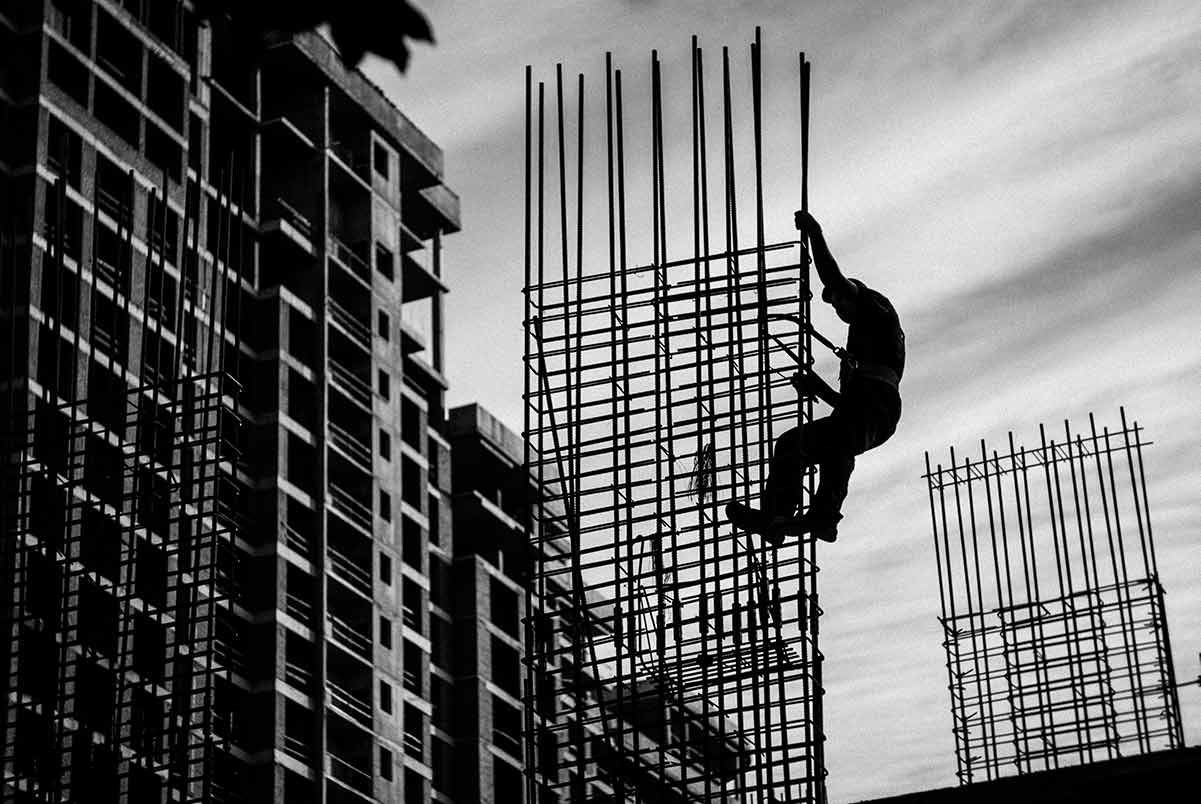 Man Working on Building Beams and Scaffolding